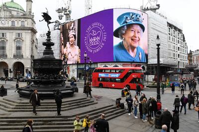 Images of Britain's Queen Elizabeth II are displayed on digital screens at Piccadilly Circus in central London to mark the platinum jubilee year. AFP