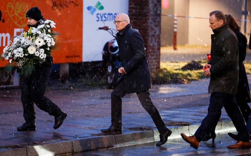 Hamburg’s First Mayor Peter Tschentscher, centre, Interior Senator Andy Grote, second right, and Second Mayor Katharina Fegebank, right, arrive at the Jehovah's Witness centre, where several people were killed. AFP