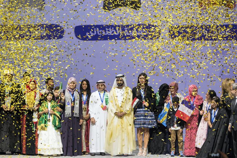 Dubai, United Arab Emirates, October 18, 2017:    Sheikh Mohammed bin Rashid Al Maktoum Prime Minister and Vice President of the United Arab Emirates and Ruler of Dubai stands with the finalists after awarding Afaf Sharef, 17, from Palestine, 7th from left, the winning trophy during the final ceremony at the Dubai Opera in the Emaar Square area of Dubai on October 18, 2017. Christopher Pike / The National

Reporter: Nawal
Section: News