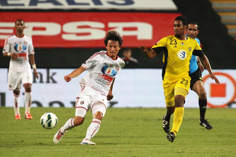 ABU DHABI , UNITED ARAB EMIRATES Ð Oct 15 : Hyungmin Shin ( no 20 in white ) of Al Jazira and Mohamed Jamal ( no 23 in yellow ) of Al Wasl in action during the Etisalat Cup round 3 football match between Al Wasl vs Al Jazira at Mohammad Bin Zayed stadium in Abu Dhabi.  ( Pawan Singh / The National ) For Sports. Story by Amit