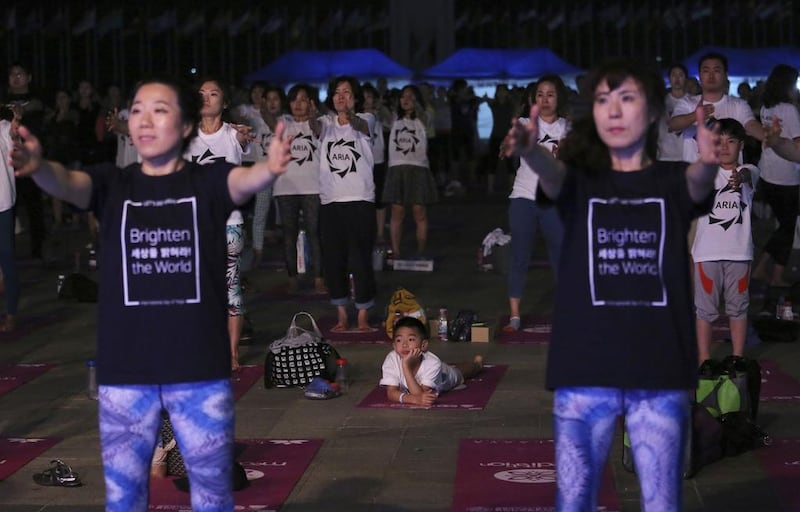People perform yoga to mark the International Day of Yoga in Seoul, South Korea. Ahn Young-joon / AP photo
