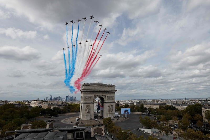 French air force's elite acrobatic flying team the Patrouille de France and the RAF's aerobatic team the Red Arrows perform a fly past. AFP