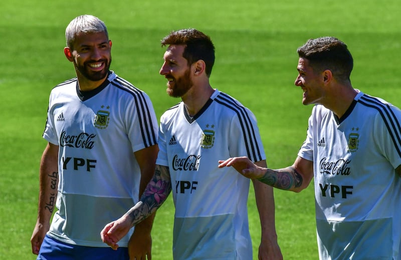 From left: Argentina's players Sergio Aguero, Lionel Messi and Rodrigo De Paul share a joke during training. AFP