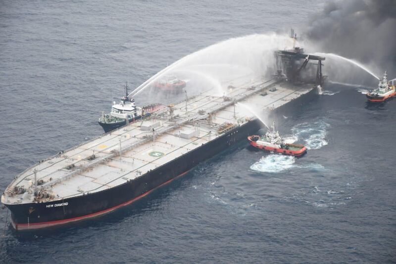 A Sri Lankan Navy boat sprays water on the New Diamond, a very large crude carrier (VLCC) chartered by Indian Oil Corp (IOC), that was carrying the equivalent of about 2 million barrels of oil, after a fire broke out off east coast of Sri Lanka. Reuters