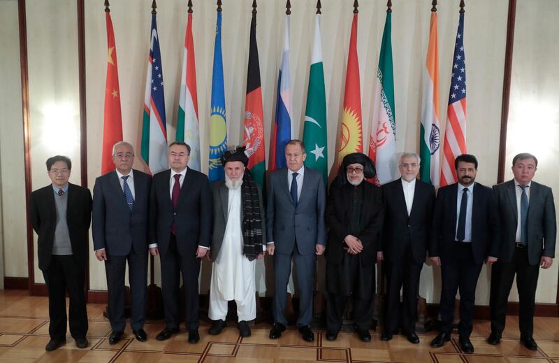 Mr Lavrov poses with all heads of delegations taking part in the peace talks. EPA