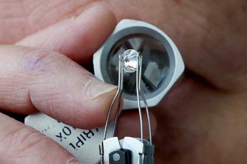 A diamond dealer checks the clarity and quality of a diamond.