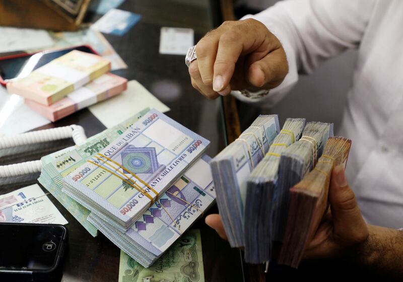 A man counts Lebanese pounds at a currency exchange shop in Beirut, Lebanon. Reuters