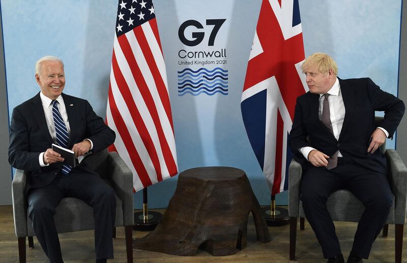 Britain's Prime Minister Boris Johnson (R) and US President Joe Biden and react during a bi-lateral meeting at Carbis Bay, Cornwall on June 10, 2021, ahead of the three-day G7 summit being held from 11-13 June.  G7 leaders from Canada, France, Germany, Italy, Japan, the UK and the United States meet this weekend for the first time in nearly two years, for the three-day talks in Carbis Bay, Cornwall. - 
 / AFP / Brendan Smialowski
