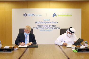 Representatives from Apex National Investment and TeraGroup sign the deal. WAM