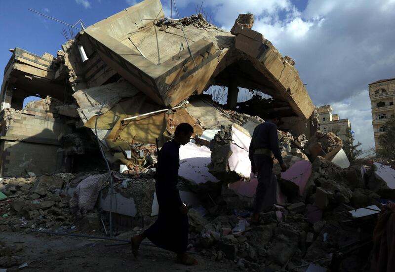 Yemenis walk through debris of a destroyed building allegedly hit by a previous Saudi-led airstrike, in Sana'a. EPA