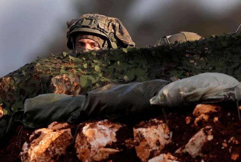 An Israeli soldier looks out from his position. AP Photo