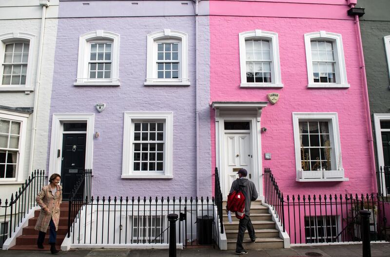 A postman delivers letters to a bright pink painted residential house in Chelsea, west London, U.K., on Thursday, Nov. 16, 2017. London's housing market is being battered from all sides. A survey by the Royal Institution of Chartered Surveyors showed a price gauge at its lowest level for seven years, and far below the national average. Photographer: Chris J. Ratcliffe/Bloomberg