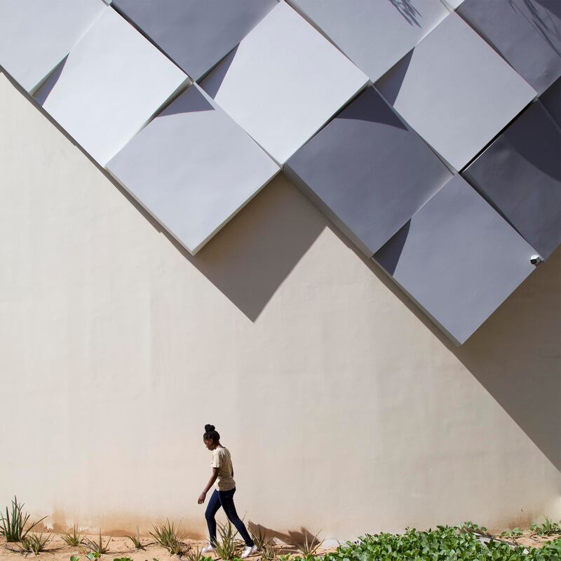 A visitor outside the Angola Pavilion, Expo 2020 Dubai. Serge Najjar/Expo 2020 Dubai