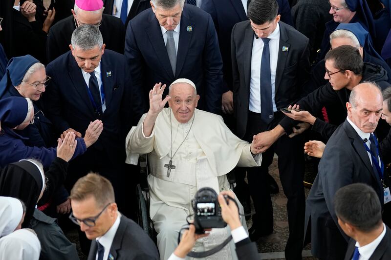 Pope Francis waves after a meeting with priests, religious leaders, seminarians and catechists at the Our Lady of Perpetual Help Cathedral in Nur-Sultan, Kazakhstan. AP