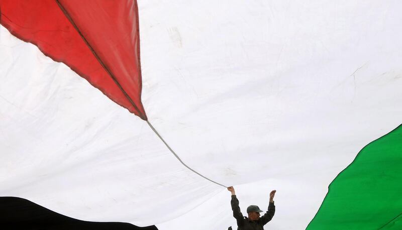 Palestinians hold a huge Palestine flag during a parade at the first Jericho Carnival 2019 in the West Bank City of Jericho.  EPA