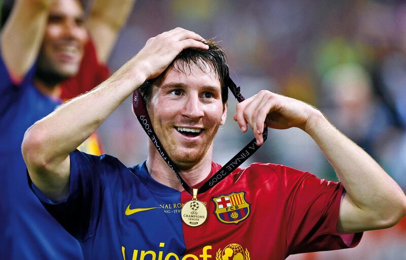 Lionel Messi of Barcelona celebrates victory with his winner's medal round his head after his side beat Manchester United in the 2009 Champions League final at the Olympic Stadium on May 27th 2009 in Rome, Italy (Photo by Tom Jenkins/Getty Images). An image from the book "In The Moment" published June 2012