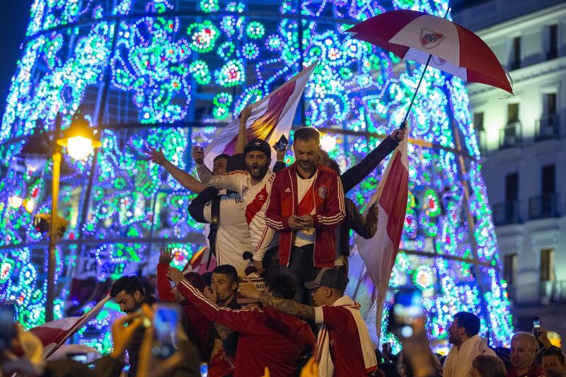 Fans of River Plate enjoy the atmosphere as they gather at Puerta del Sol Square. Getty Images