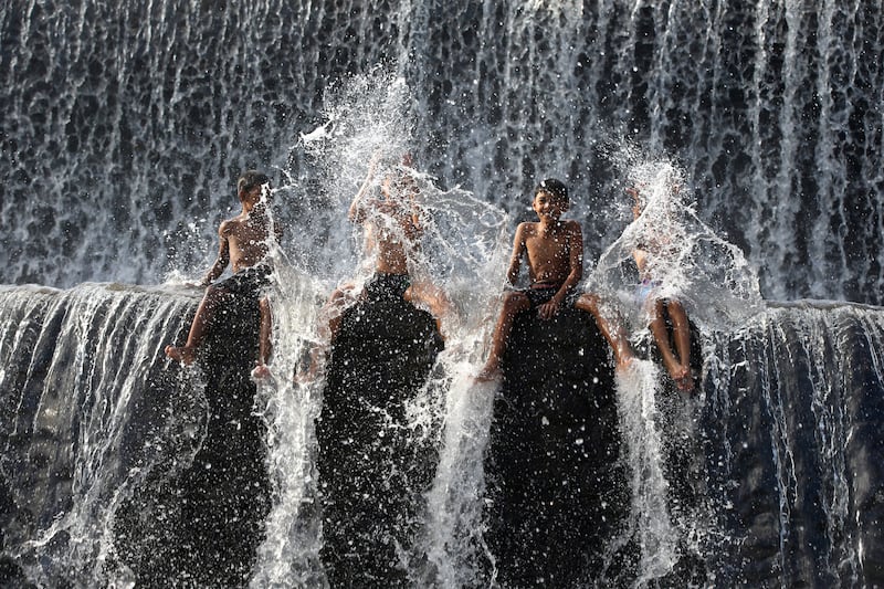 Children play at a dam on the Unda River, in Klungkung, Bali. AP