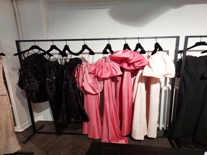 Two new elements for spring/summer 2023: sequins in the dark gleam of the black dresses, left, and the pink of the Barbiecore trend.