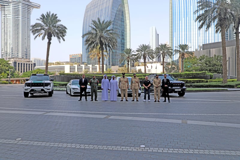 Dubai Police showcase their smart vehicles next to Burj Khalifa.