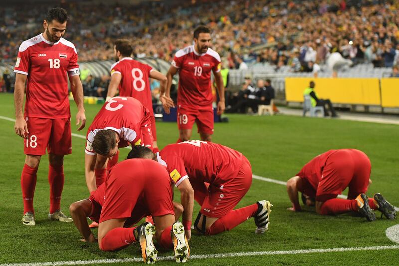 Syria's players celebrate after teammate Omar Alsoma scored the opening goal. Dean Lewins / EPA