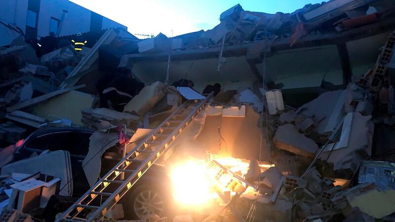 People search at a damaged hotel after an earthquake, in Durres, western Albania. AP Photo