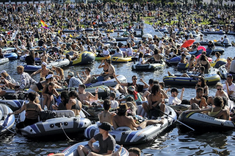 People attend a rave in boats of all sizes to give support to Berlin's world renowned dance clubs which are struggling due to coronavirus COVID-19 pandemic on the Landwehr canal on May 31, 2020 in Berlin's Kreuzberg district. (Photo by David GANNON / AFP)