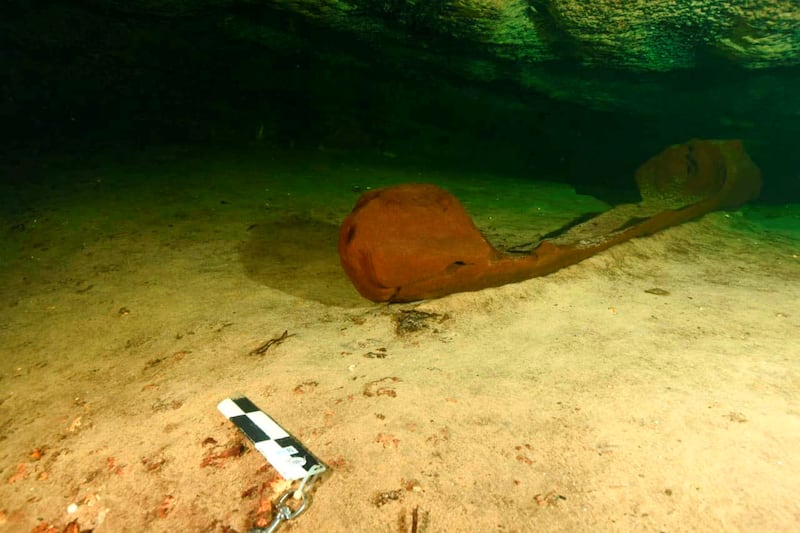 A wooden canoe used by the ancient Maya and believed to be over a thousand years old is pictured at a fresh-water pool known as a cenote and found during the archeological work accompanying the construction of a controversial new tourist train, in the state of Yucatan, in this handout released on October 29, 2021.  Mexico's National Institute of Anthropology and History (INAH)/Handout via REUTERS ATTENTION EDITORS - THIS IMAGE HAS BEEN SUPPLIED BY A THIRD PARTY.  NO RESALES.  NO ARCHIVES