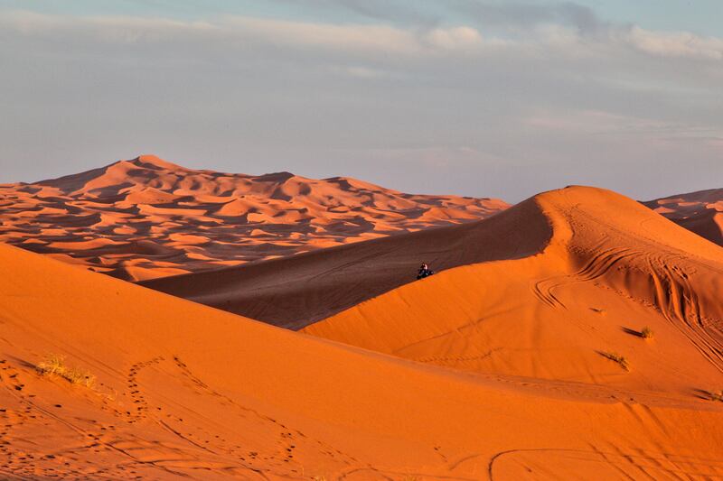 Tourists ride an ATV along the sand dunes at just before sunset in Erg Chebbi desert near the small Moroccan village of Merzouga in the Sahara Desert. Reuters