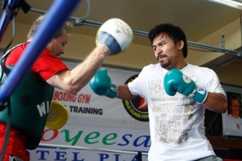 Manny Pacquiao, right, will train with Freddie Roach, left, for a fight against Floyd Mayweather Jr.