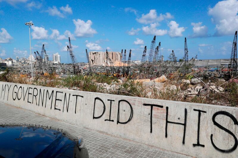 A picture taken on August 9, 2020, shows graffiti on the wall of a bridge overlooking the port of Beirut, the site of the explosion which killed at least 154 people and devastated swathes of the capital.  / AFP / european afp / ANWAR AMRO
