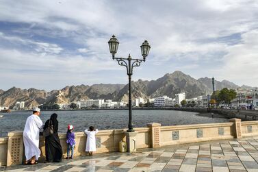 An Omani family stands by the waterfront in the Mutrah area of the capital Muscat on November 16, 2018. (Photo by GIUSEPPE CACACE / AFP)