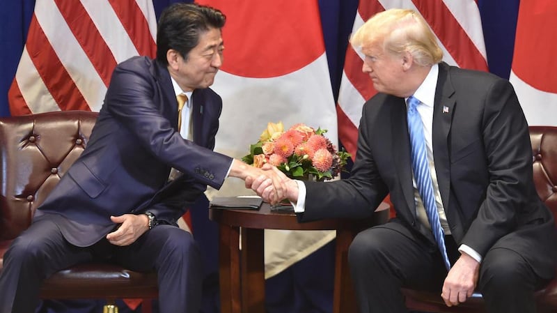 Japanese Prime Minister Shinzo Abe and US President Donald Trump agreed to exclude Japan's politically sensitive rice industry from the agricultural market opening. Mr Trump is eager to make a deal appease US farmers and boost his re-election chances. AFP
