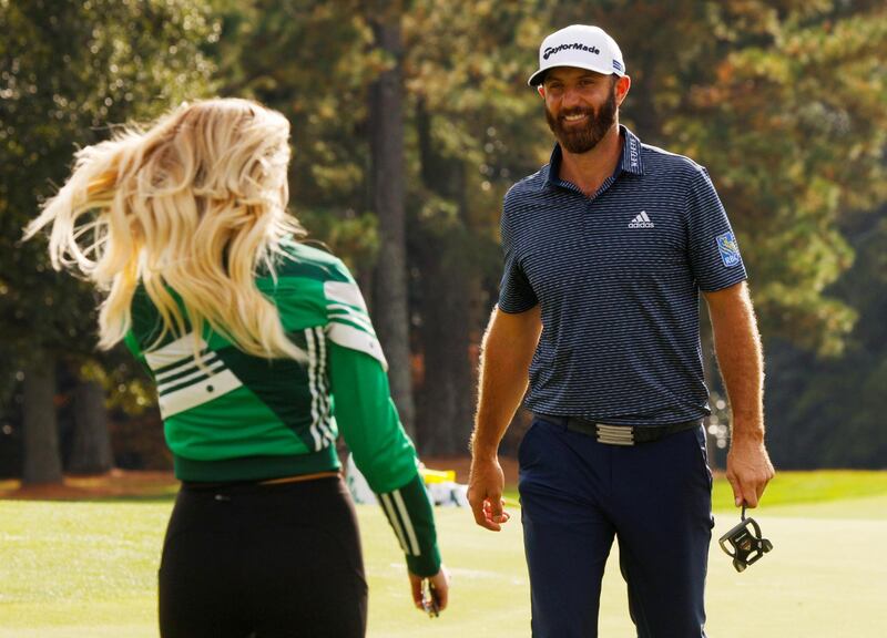 Dustin Johnson celebrates with partner Paulina Gretzky on the 18th green after winning The Masters. Reuters