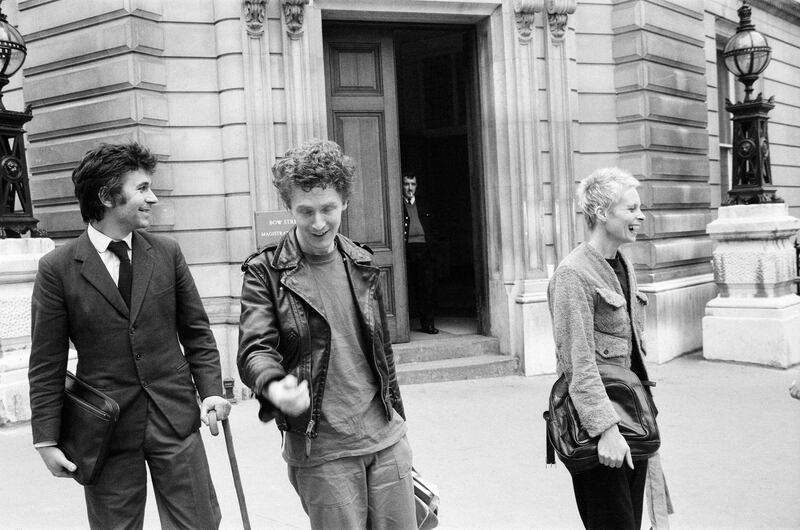 Malcolm McLaren, centre, manager of punk rock band Sex Pistols, with Westwood outside a British court in 1977. Getty Images