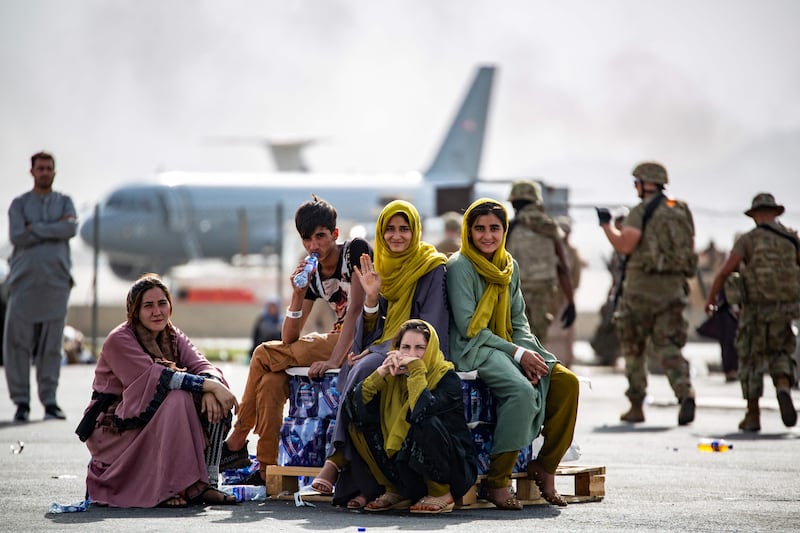 Children wait for the next flight at Hamid Karzai International Airport. AFP