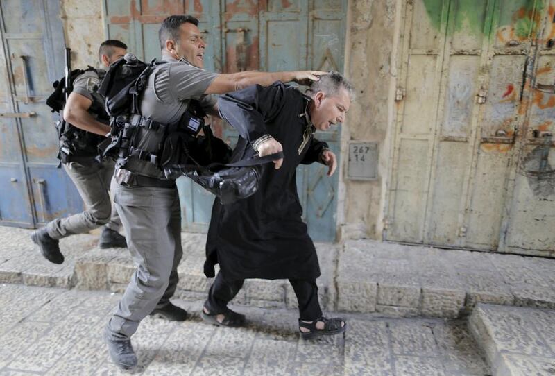 Israeli border police officers detain a Palestinian protester in Jerusalem's Old City. Ammar Awad / Reuters