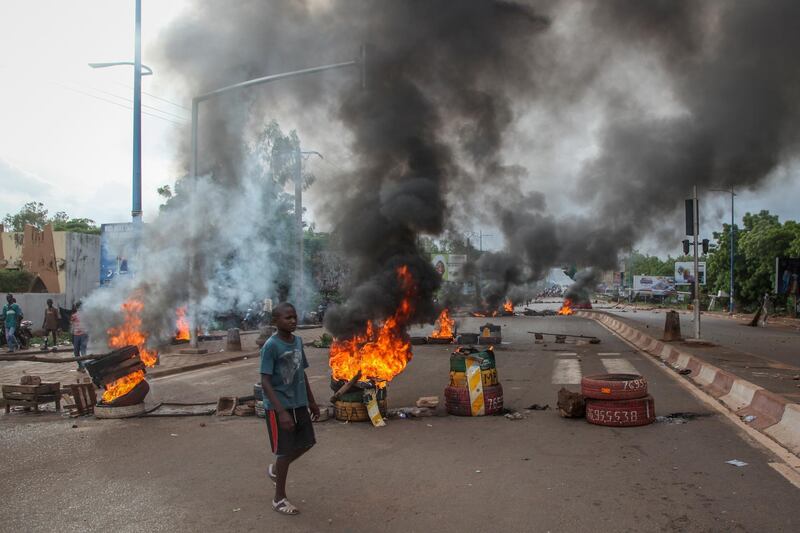 Anti-government protesters burn tires and barricade roads in the capital Bamako, Mali. AP Photo