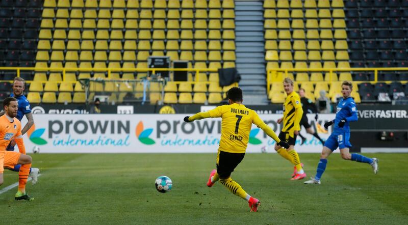 Dortmund's Jadon Sancho scores against Hoffenheim goalkeeper Oliver Baumann. AFP