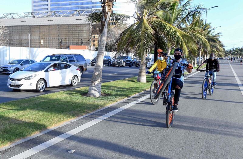 Saudi youths ride bicycles at the seafront promenade in the Saudi port city of Jeddah.  AFP