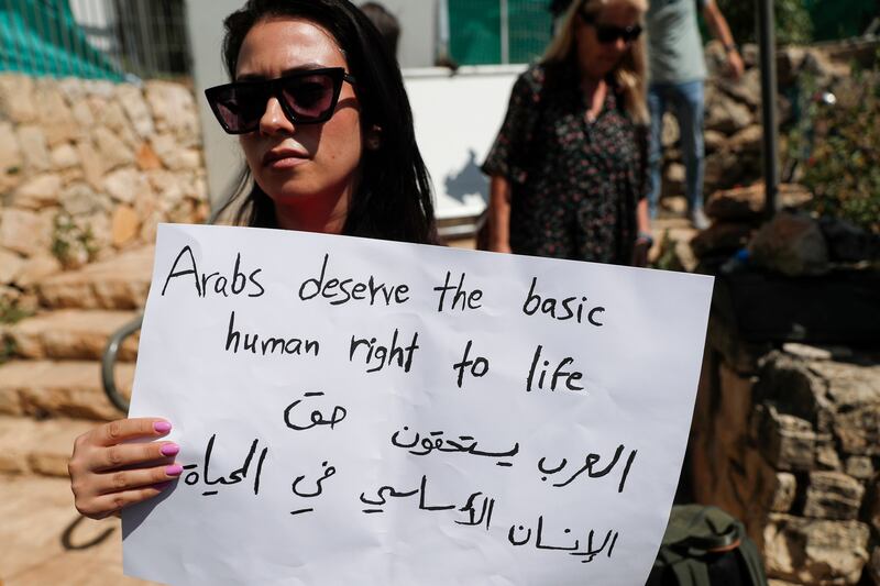A woman holds a sign during a protest by Israeli-Arabs in Jerusalem to demand action on crime in the Arab community. EPA