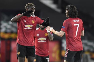 epa09168643 Paul Pogba (L) of Manchester United celebrates with teammate Edison Cavani (R) after scoring the 5-2 lead during the UEFA Europa League semi final, first leg soccer match between Manchester United and AS Roma at Old Trafford in Manchester, Britain, 29 April 2021. EPA/PETER POWELL