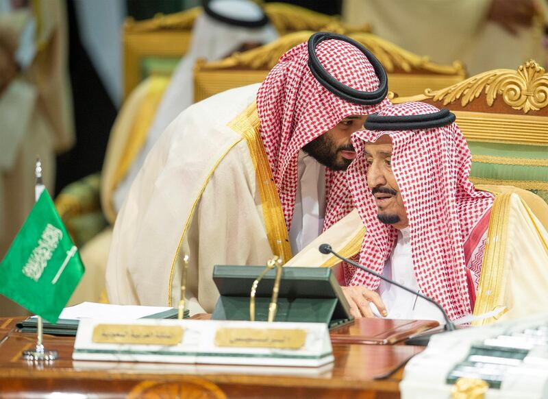 King Salman speaks with Crown Prince Mohammed during the conference. EPA