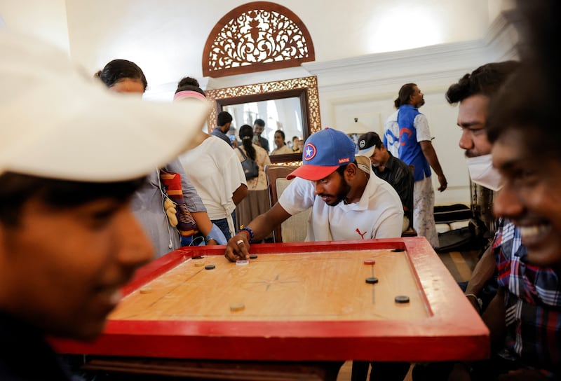Youths play carrom inside the Sri Lankan prime minister's official residence, which was stormed by protesters at the weekend. Reuters
