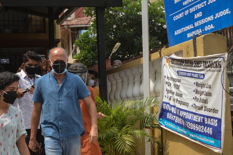 Journalist Tarun Tejpal (R), leaves after the verdict hearing of a sexual assault case in which he is accused of raping a female journalist in the lift of a five-star hotel in Goa in November 2013 was postponed due to shortage of staff, at the district court of Mapusa in Goa on May 12, 2021.   / AFP / Umesh ZARMEKRA
