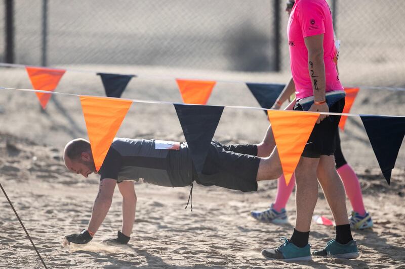 DUBAI, UNITED ARAB EMIRATES - DECEMBER 7, 2018. 

People partake in the Tough Mudder challenge in Hamdan Sports Complex.

du Tough Mudder is a mud and obstacle course designed to test participant's physical strength, stamina, and mental grit. It is a team-oriented challenge with no winners, finisher medals, or clocks to race against. 

(Photo by Reem Mohammed/The National)

Reporter:
Section:  NA