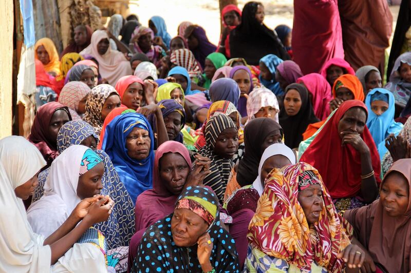 Women gather during a burial ceremony, after two people were killed by Boko Haram fighters in Dalori camp for internally displaced people, near Maiduguri, on July 26, 2019. Two people were killed and several wounded when Boko Haram fighters raided a camp for people displaced by the jihadist conflict in northeast Nigeria, emergency services said on July 26, 2019. Dozens of Islamist militants on motorcycles and two motorised rickshaws stormed into Dalori camp on Thursday, shooting people and looting food supplies after overrunning a nearby military base.
 / AFP / Audu MARTE
