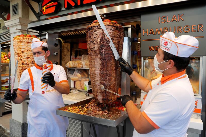 Cooks prepare traditional Doner kebab for clients at a small restaurant in Istanbul, Turkey. Reuters