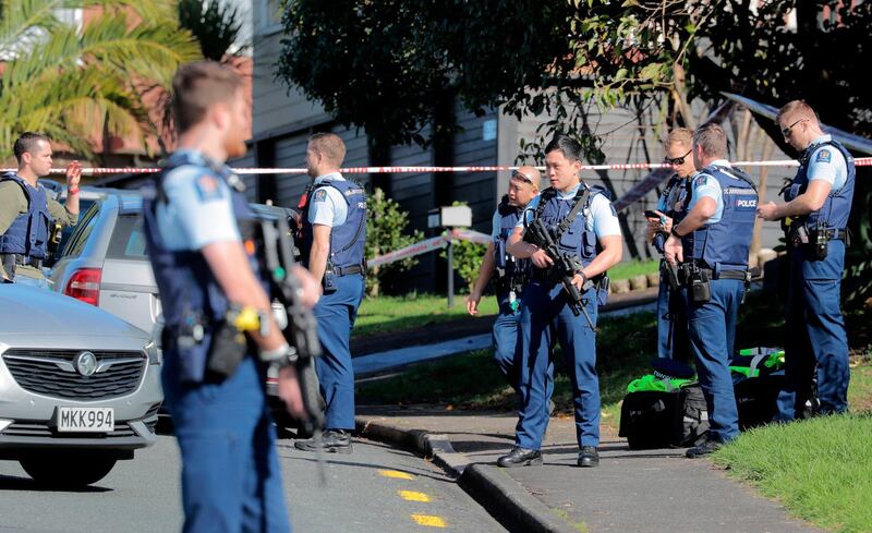 Armed police gather at the scene of a shooting incident following a routine traffic stop in Auckland. New Zealand Herald via AP