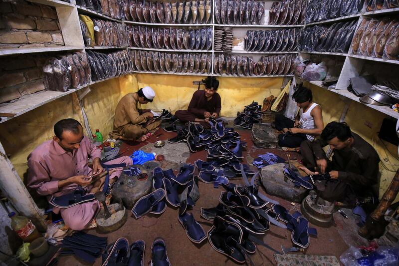 Pakistani cobblers make traditional Peshawari Chappal shoes ahead of the Eid al-Fitr  in Peshawar, Pakistan.  EPA